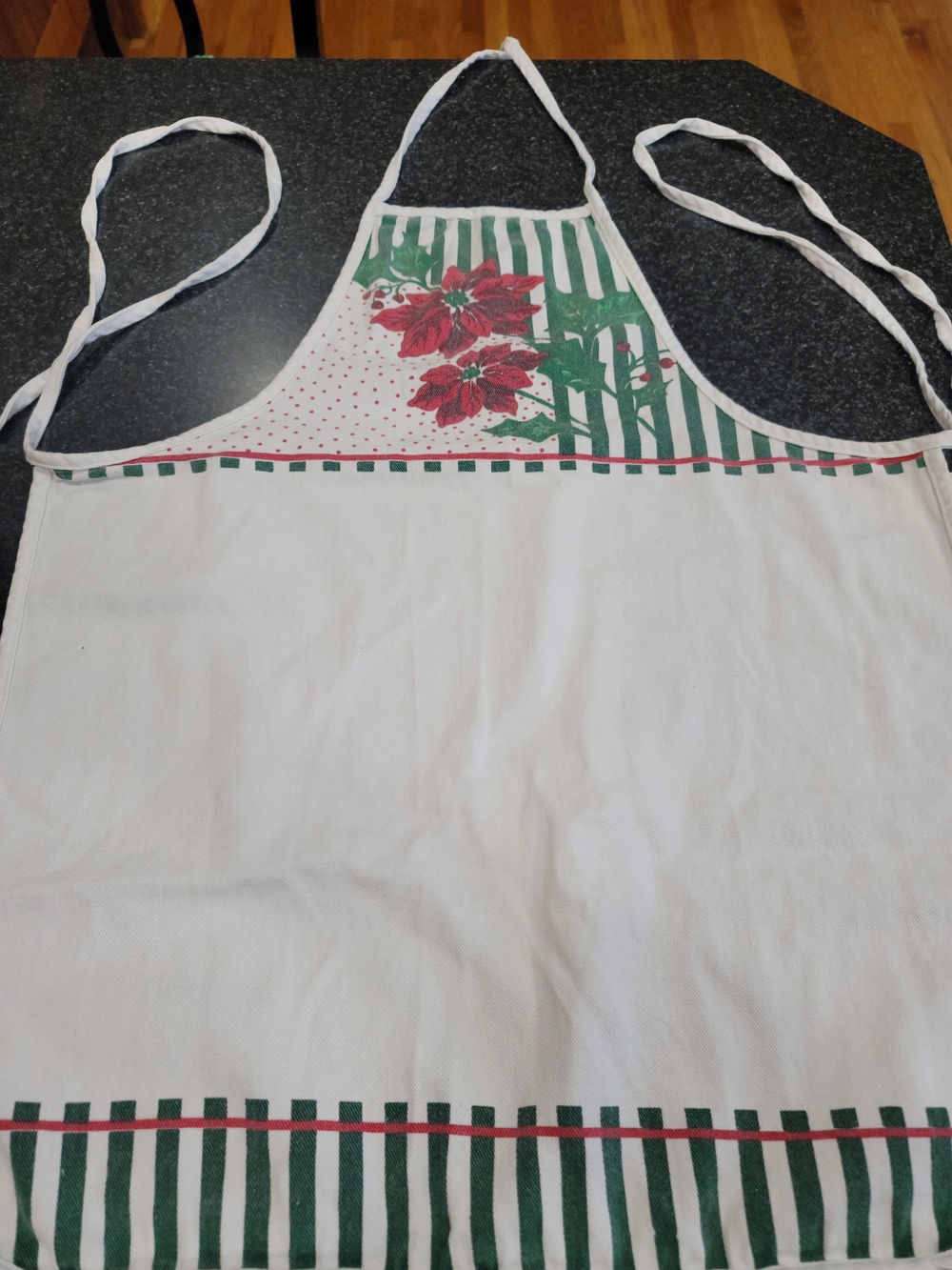 Vintage Christmas holiday apron featuring red poinsettias, green holly leaves